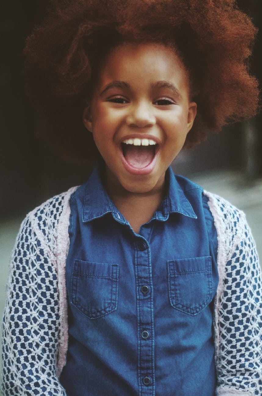 Black girl with brown afro smiling